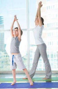 Mum and son practicing yoga